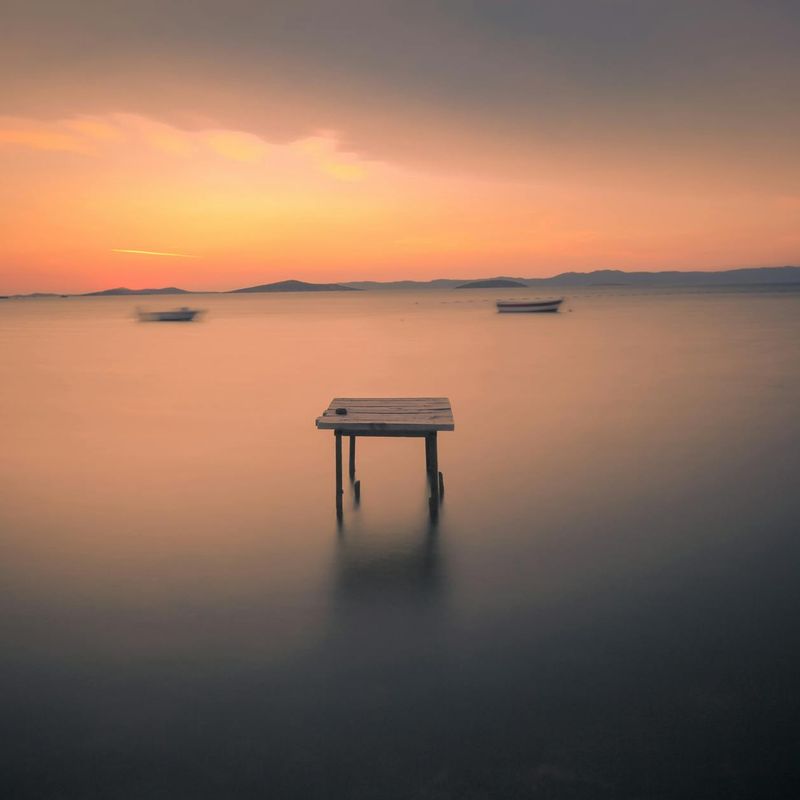 A serene landscape with soft light and calm water.