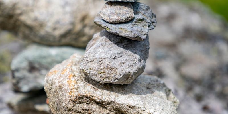 Perfectly balanced stones stacked on a blurred background.